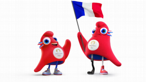 Mascostes da próxima olimpiada, segurando a bandeira do país cede, a França